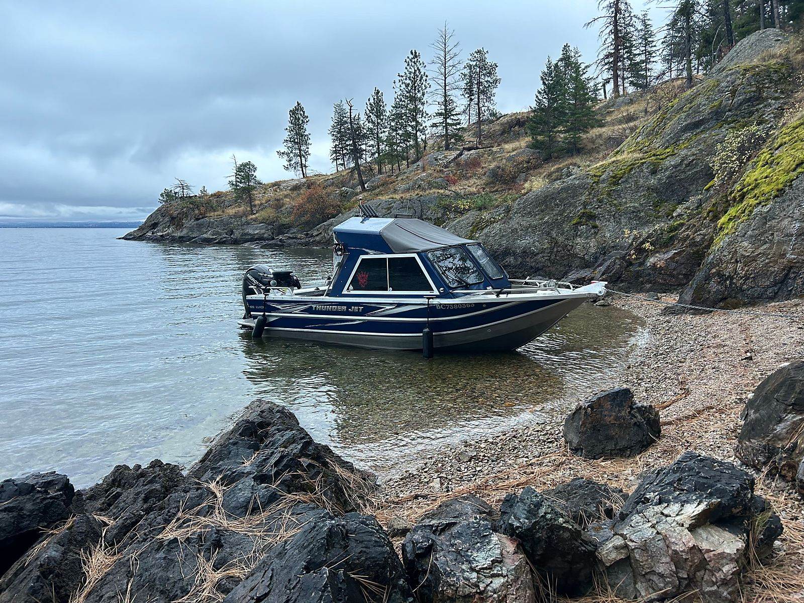 The boat pulled up on a rocky Okanagan shoreline