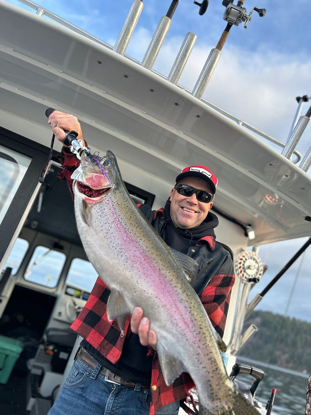 Rainbow trout hoisted aboard at the end of the fight