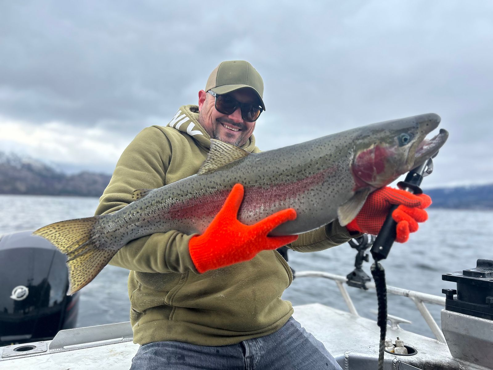A heavy Okanagan rainbow trout held up on the boat