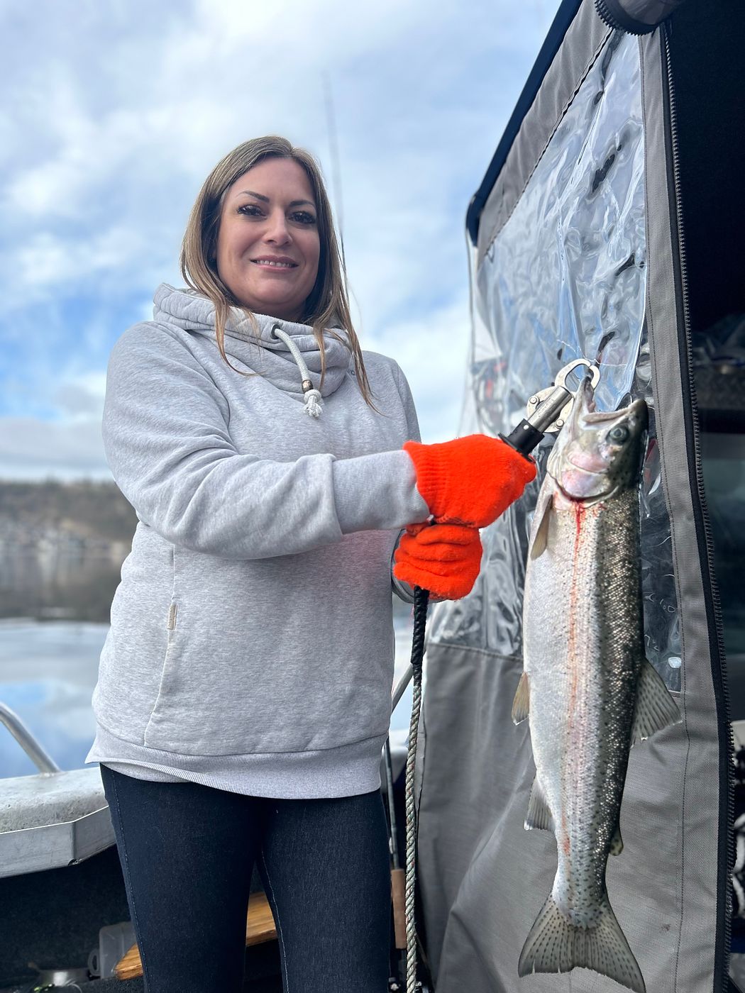 Guest holding a rainbow trout caught on a guided charter